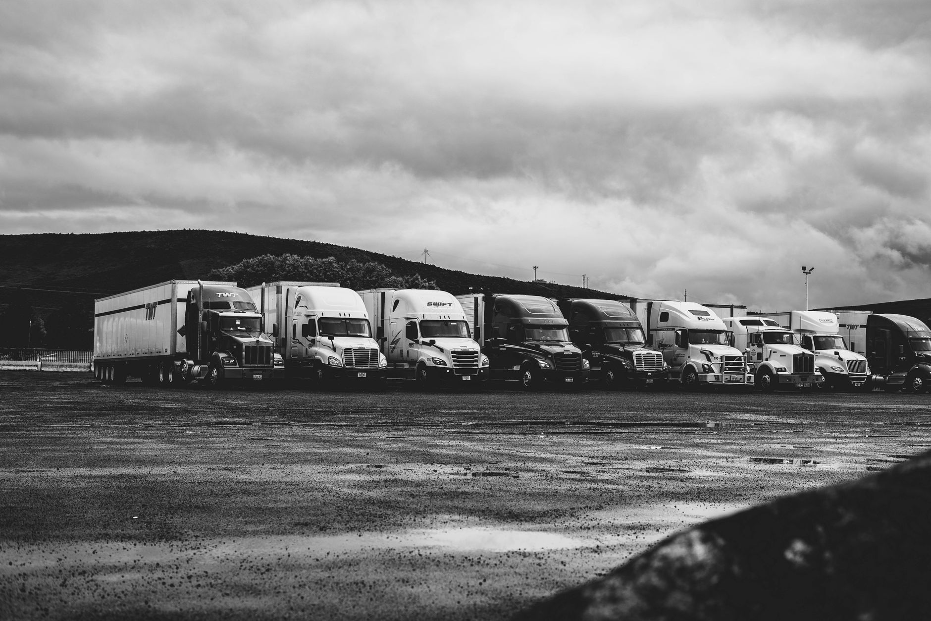A fleet of commercial trucks on the highway